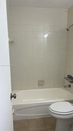a bathroom with a toilet and a bath tub