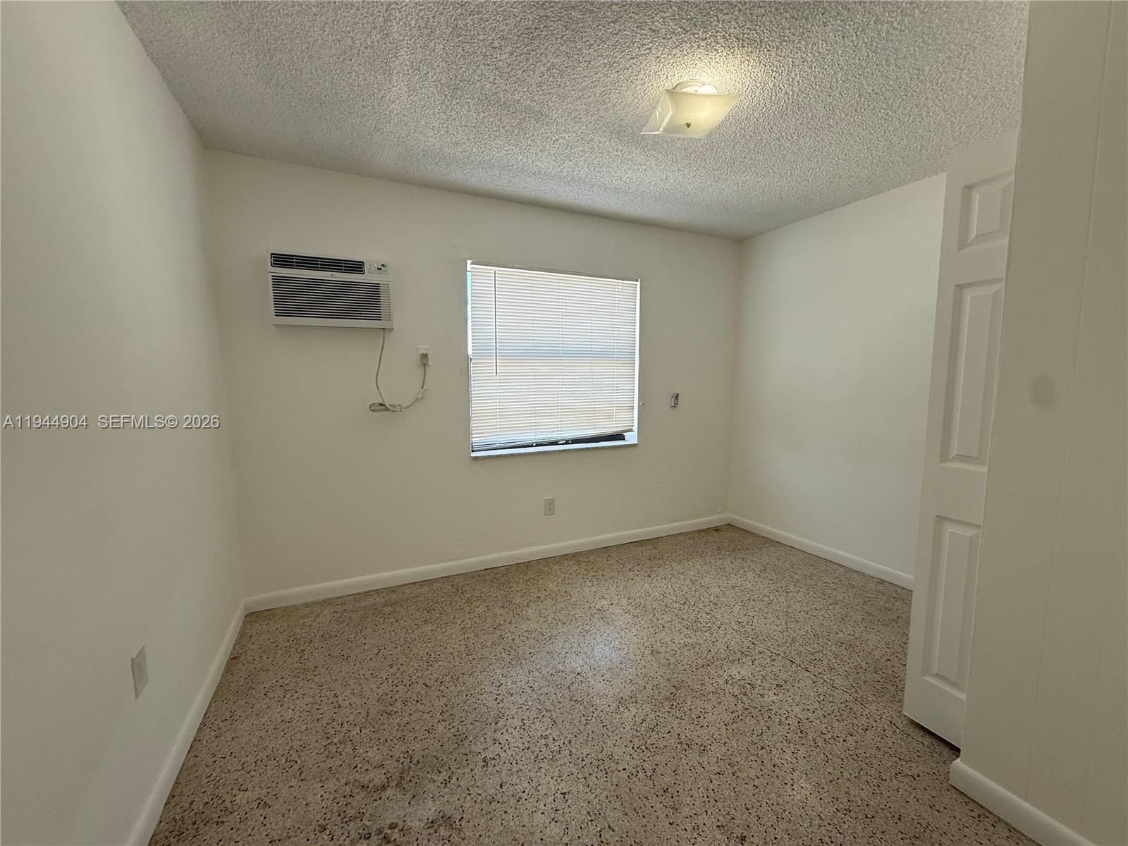59 West 26th Street, Unit 6 Hialeah, FL 33010 - Photo 4 of 6 an empty room with a window