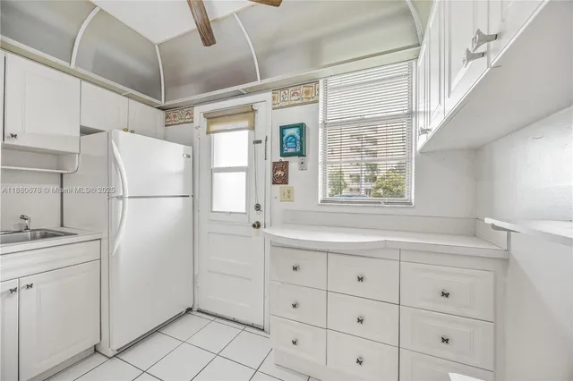a white refrigerator freezer sitting inside of a kitchen