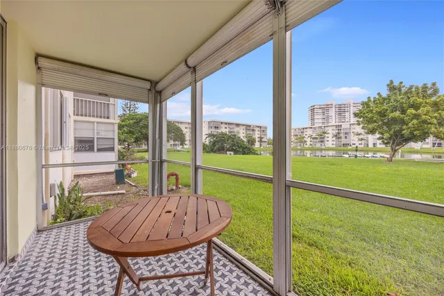 a view of a porch with furniture and yard