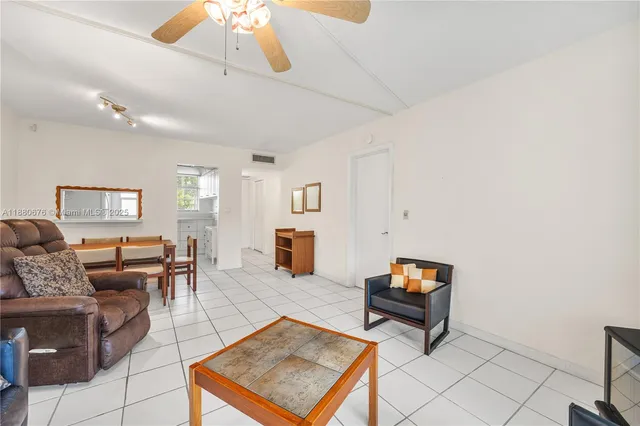 a living room with furniture a rug and a chandelier