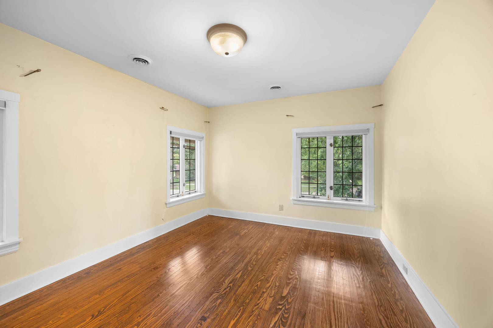 260 Maplewood Road Riverside, IL 60546 - Photo 33 of 48 an empty room with wooden floor and windows