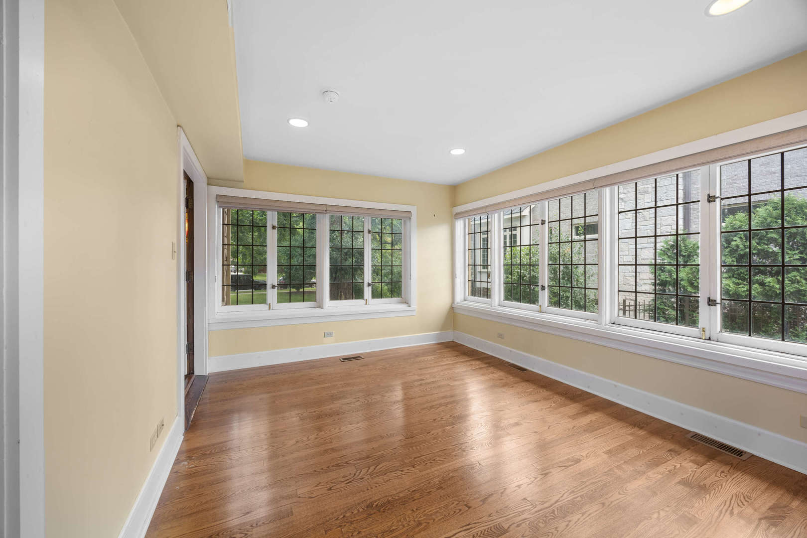 260 Maplewood Road Riverside, IL 60546 - Photo 10 of 48 a view of an empty room with wooden floor and a window