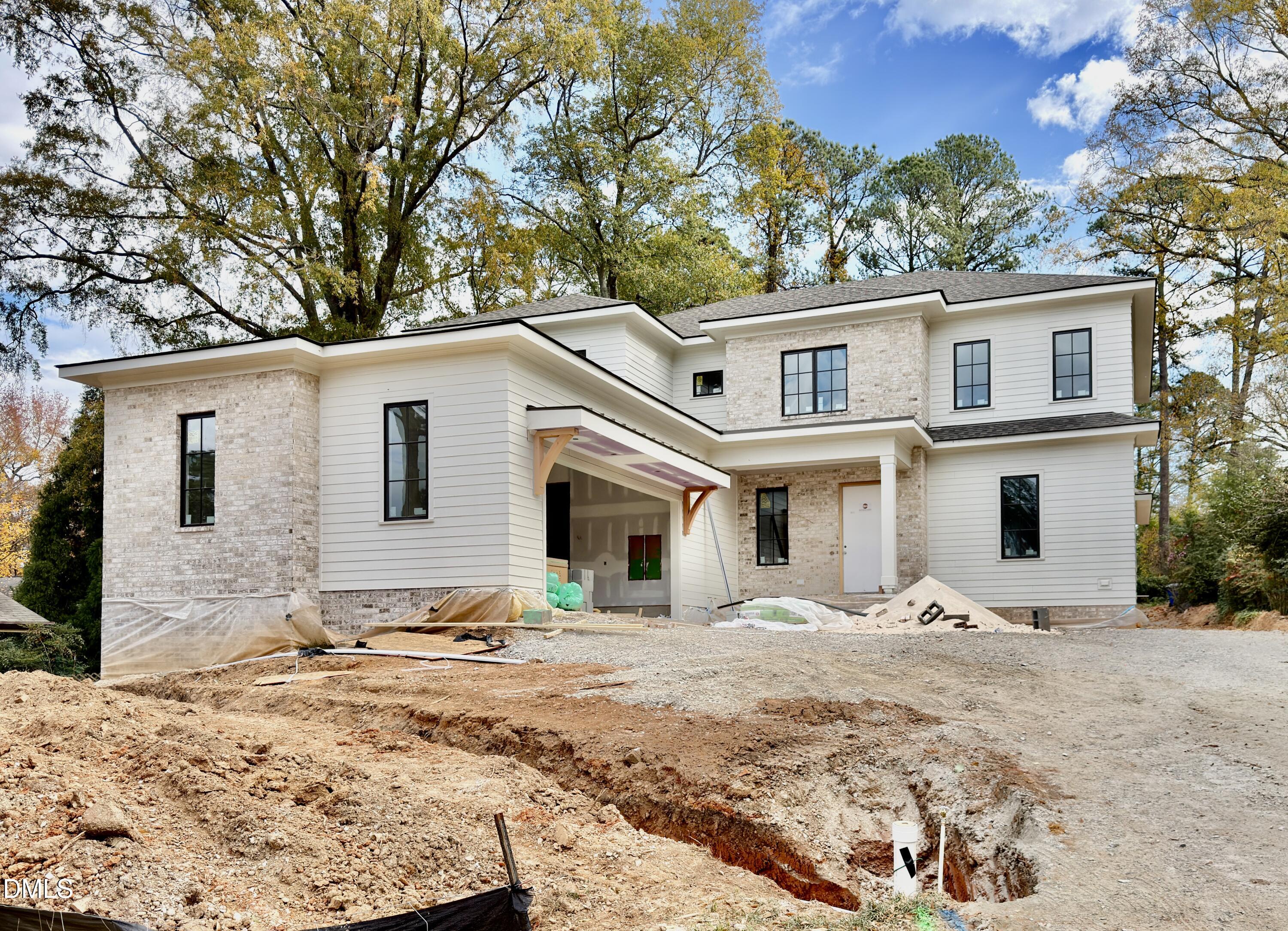 a view of a white house with a yard covered in snow