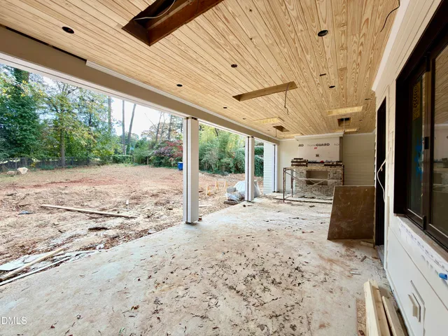 a view of a room with wooden floor and windows