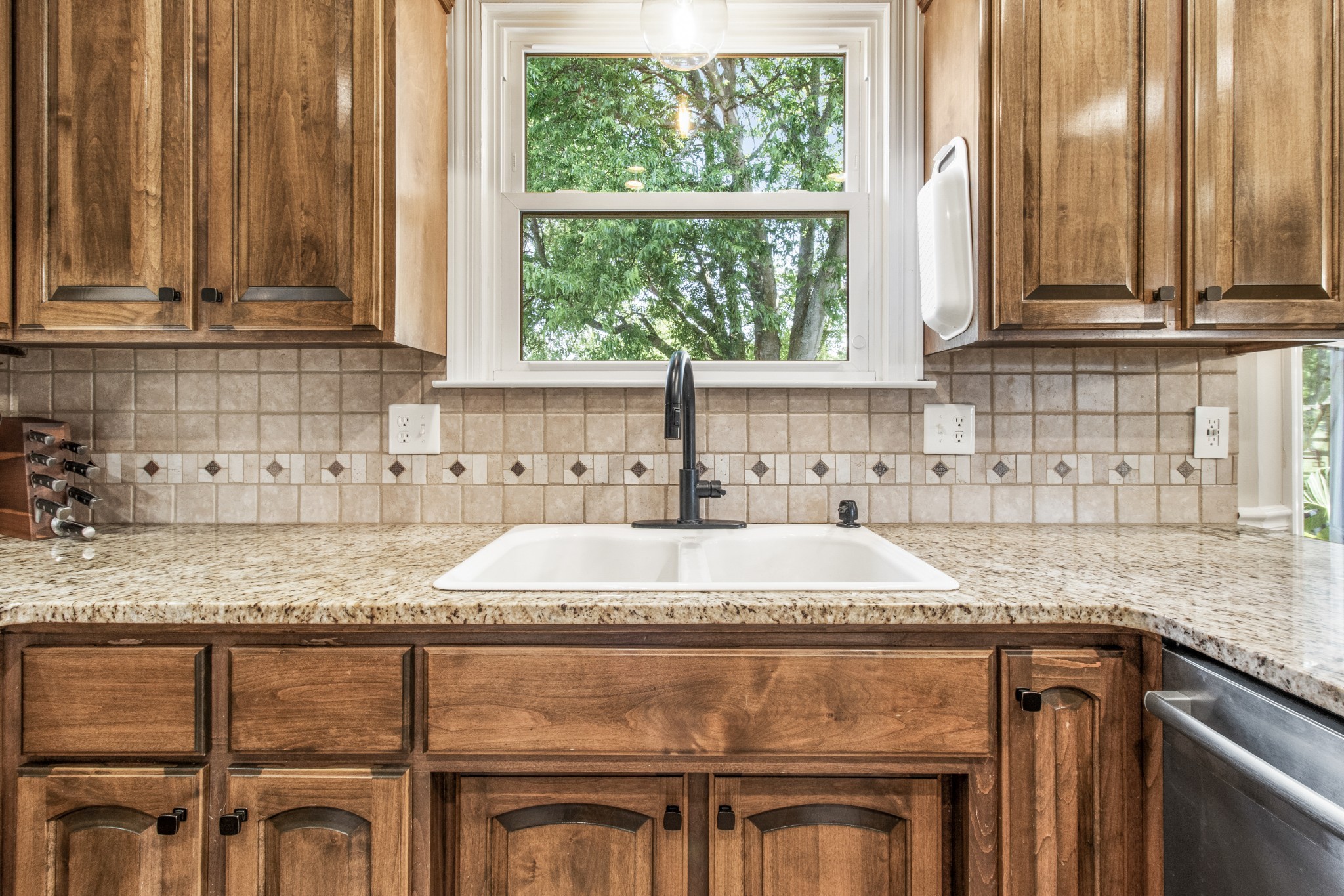2203 Springlot Road Clarksville, TN 37043 - Photo 12 of 36 a kitchen with granite countertop a sink a stove and cabinets
