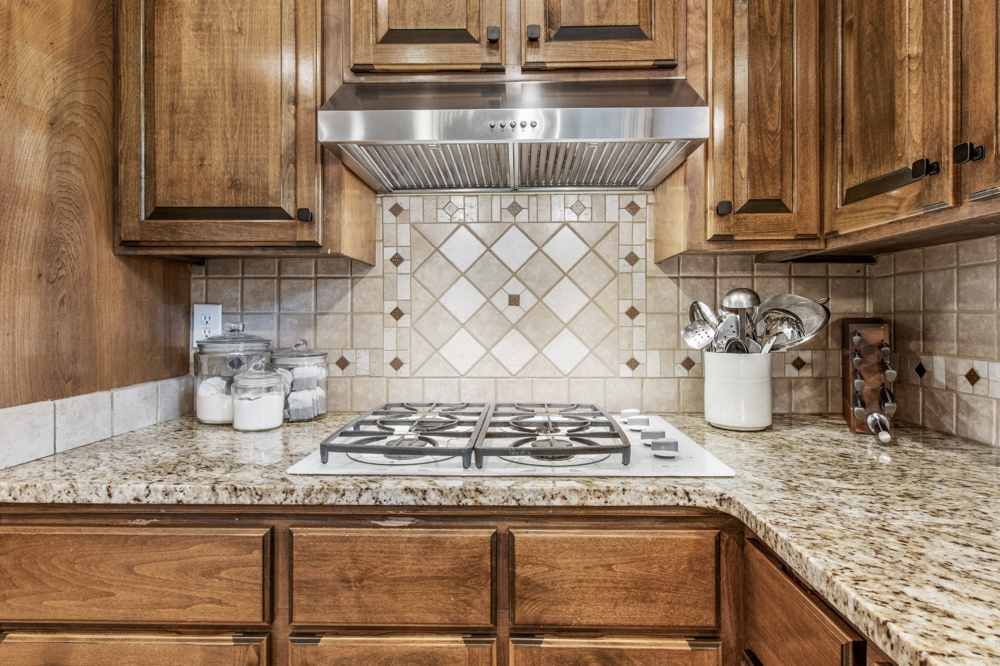 2203 Springlot Road Clarksville, TN 37043 - Photo 13 of 36 a kitchen with granite countertop wooden cabinets and a stove top oven