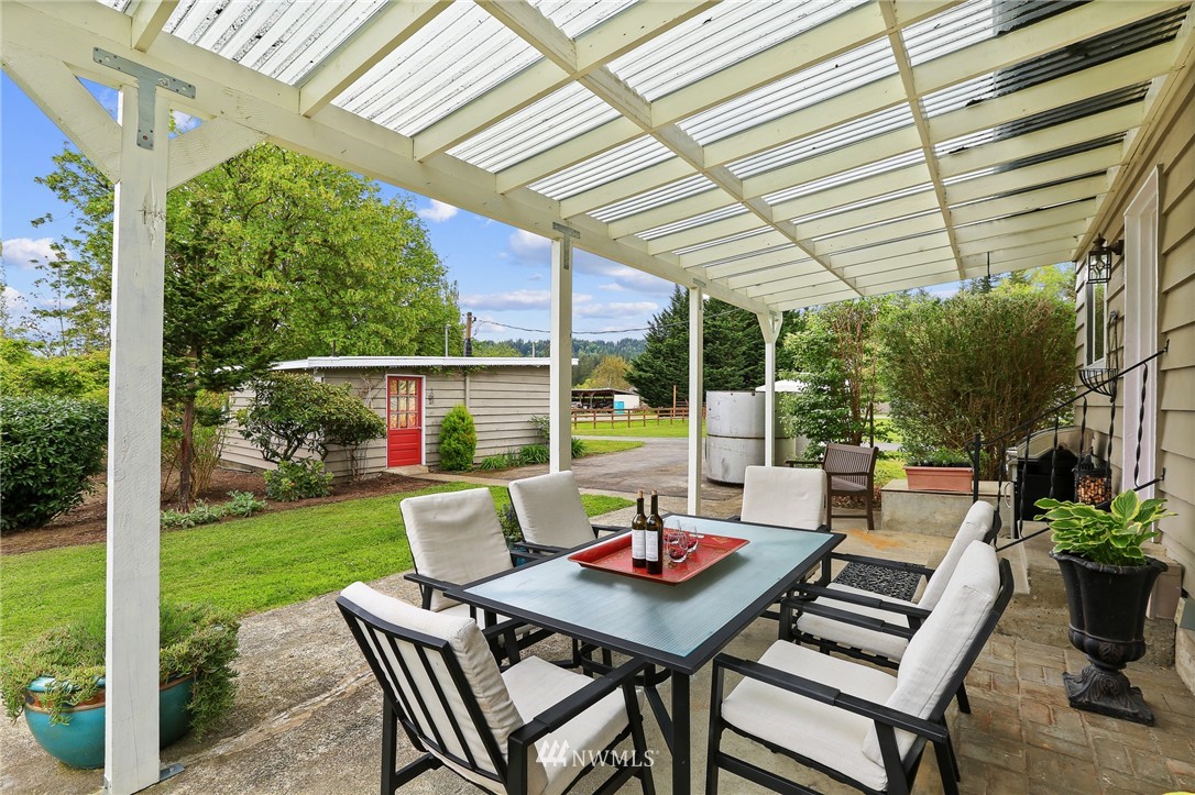 4440 Preston-Fall City Road Southeast Fall City, WA 98024 - Photo 22 of 38 a view of a patio with a table chairs and a backyard