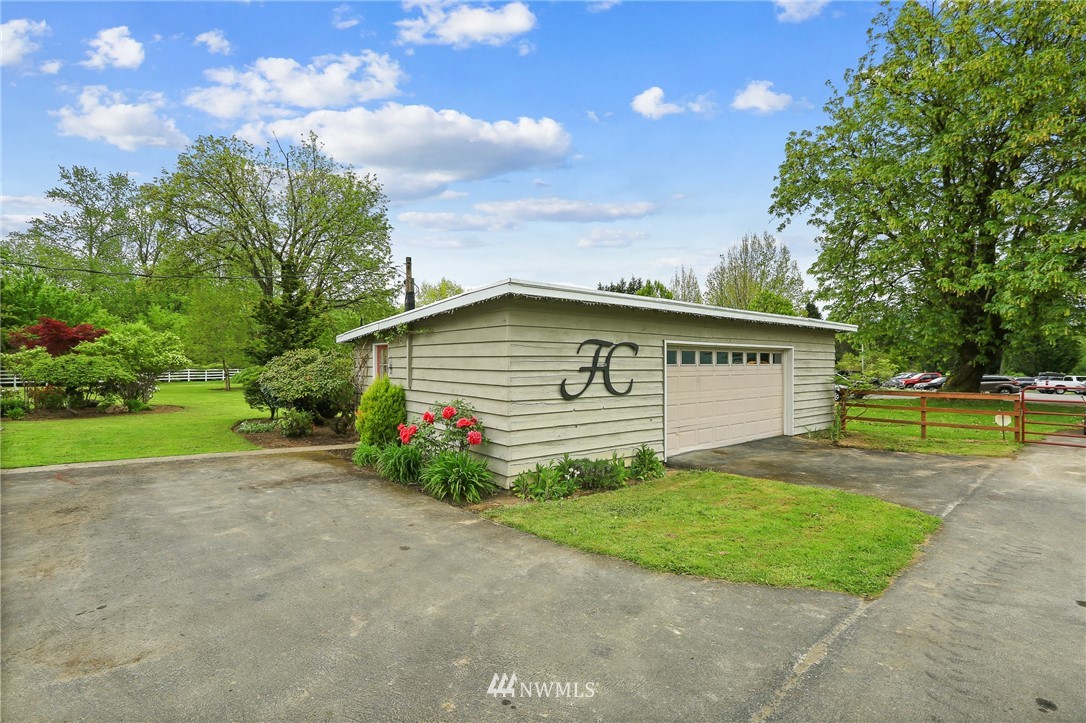 4440 Preston-Fall City Road Southeast Fall City, WA 98024 - Photo 23 of 38 a view of a house with a backyard and a garage