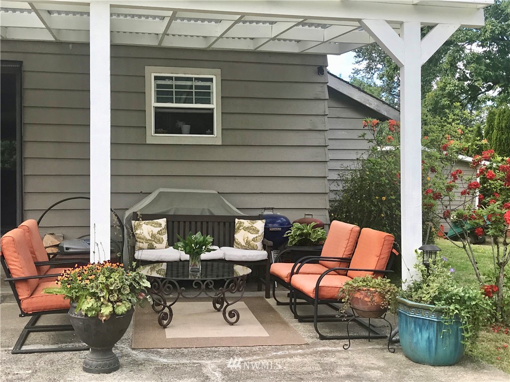 4440 Preston-Fall City Road Southeast Fall City, WA 98024 - Photo 35 of 38 a view of patio with a table and chairs and potted plants