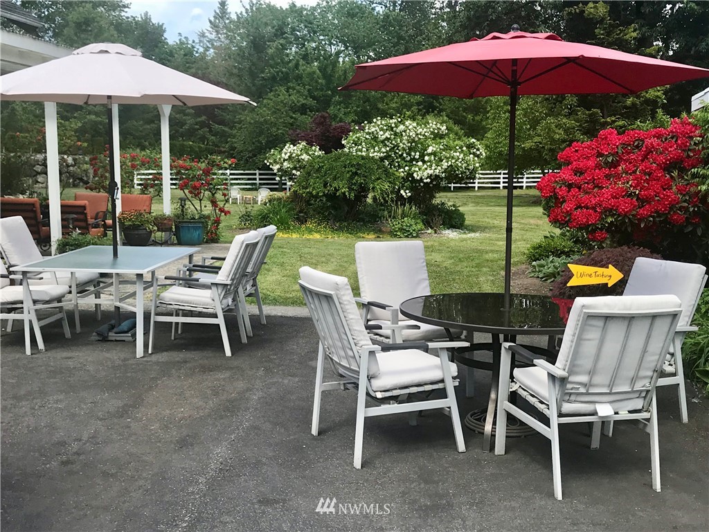 4440 Preston-Fall City Road Southeast Fall City, WA 98024 - Photo 36 of 38 a patio with a table and chairs under an umbrella