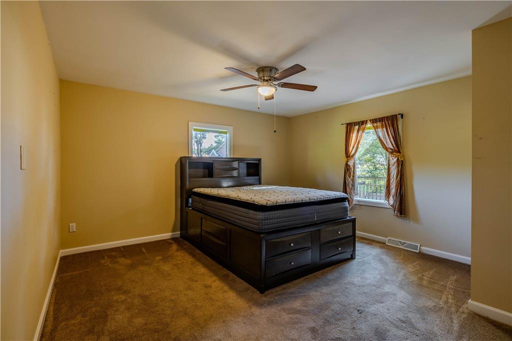 4 Colonial Drive Rome, GA 30165 - Photo 20 of 31 a room with a bed and a ceiling fan