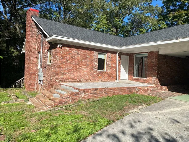 a backyard of a house with yard and outdoor seating
