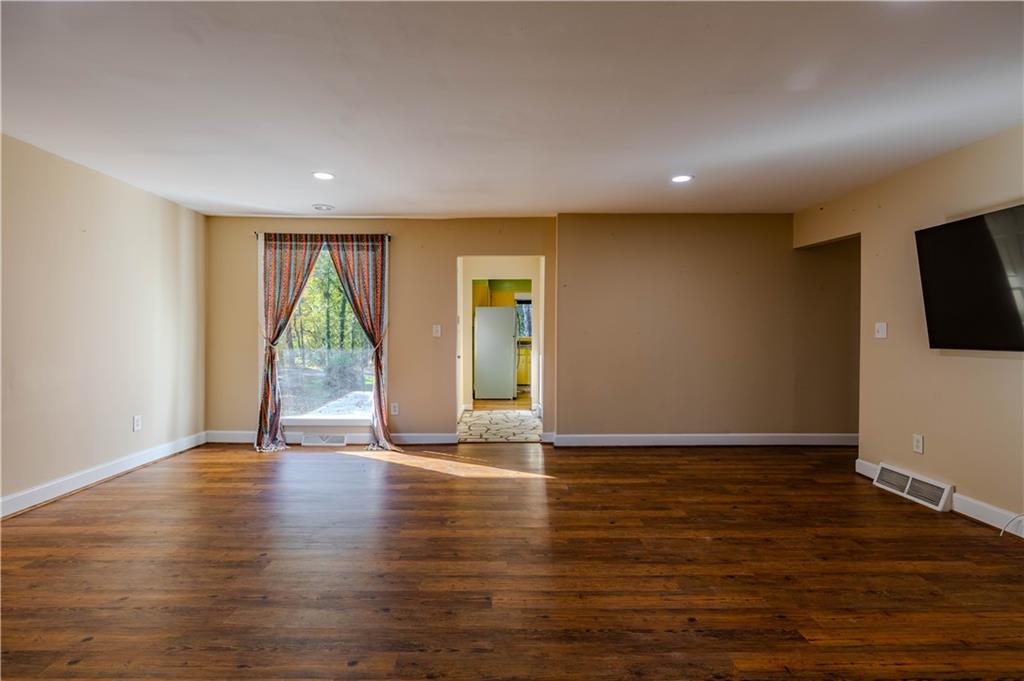 4 Colonial Drive Rome, GA 30165 - Photo 5 of 31 a view of an empty room with wooden floor and a window