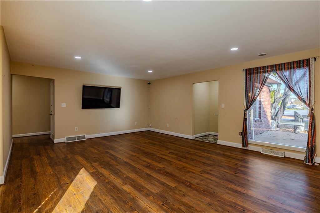 4 Colonial Drive Rome, GA 30165 - Photo 7 of 31 a view of an empty room with wooden floor and a window