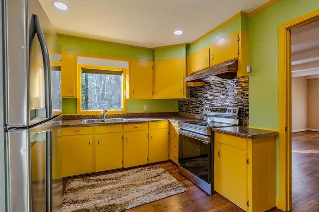 a kitchen with a sink and refrigerator