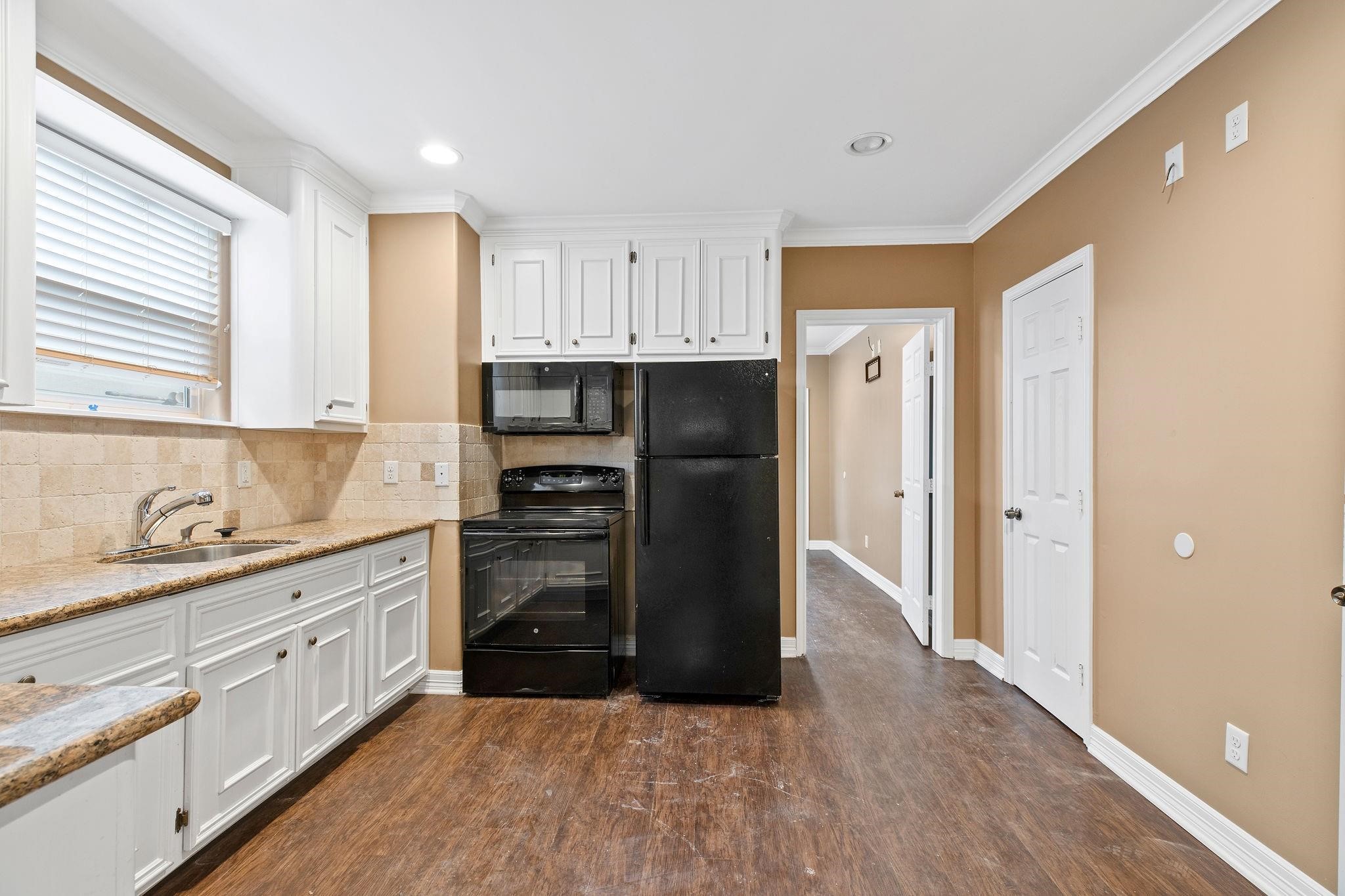 4306 Wilmer Street, Unit 2 Houston, TX 77003 - Photo 16 of 17 a kitchen with stainless steel appliances a refrigerator sink and cabinets