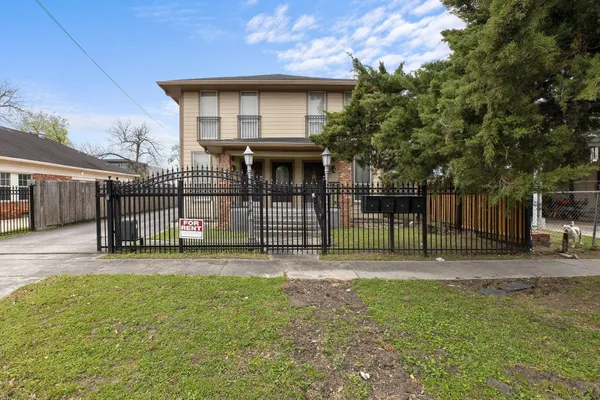 a view of a house with a backyard and a tree