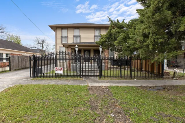 a view of a house with a backyard and a tree