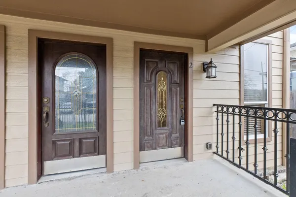 a front view of a house with a glass door and a porch