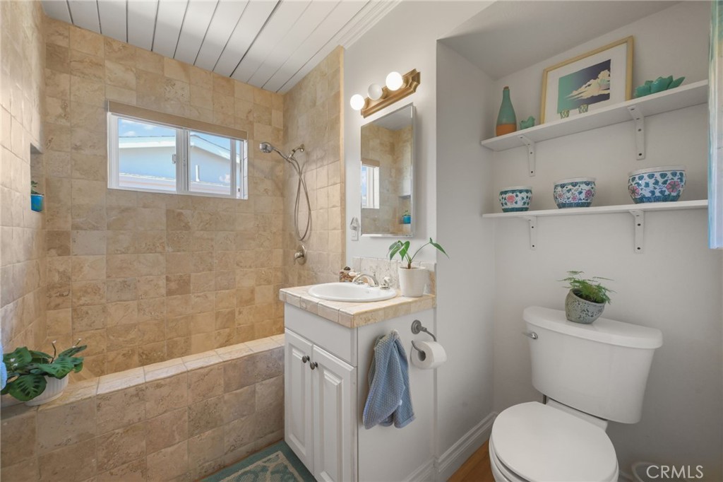 34041 El Contento Dana Point, CA 92629 - Photo 19 of 23 2nd bath which also doubles as a guest bathroom. The shower-tub is all travertine tile as is the sink vanity.