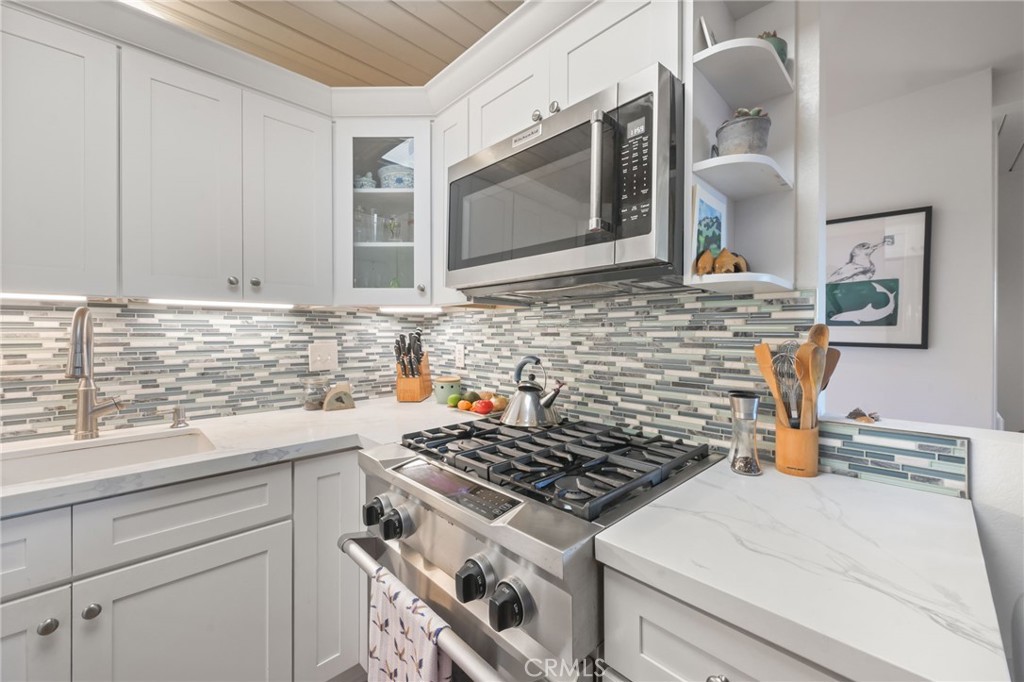 34041 El Contento Dana Point, CA 92629 - Photo 5 of 23 A partial look at the kitchen remodeled in 2021, with quartz countertops, new backsplash, all new appliances, new cabinets, and new flooring.