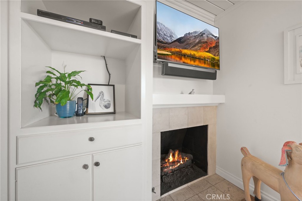 34041 El Contento Dana Point, CA 92629 - Photo 9 of 22 a hallway with a fireplace and a potted plant