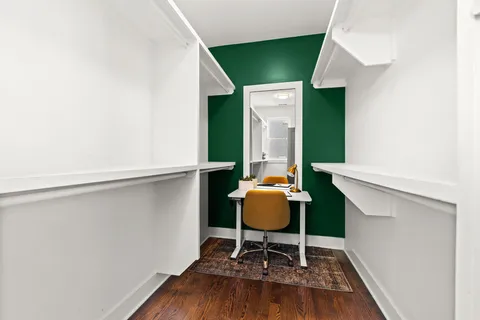 a work room with furniture and a potted plant
