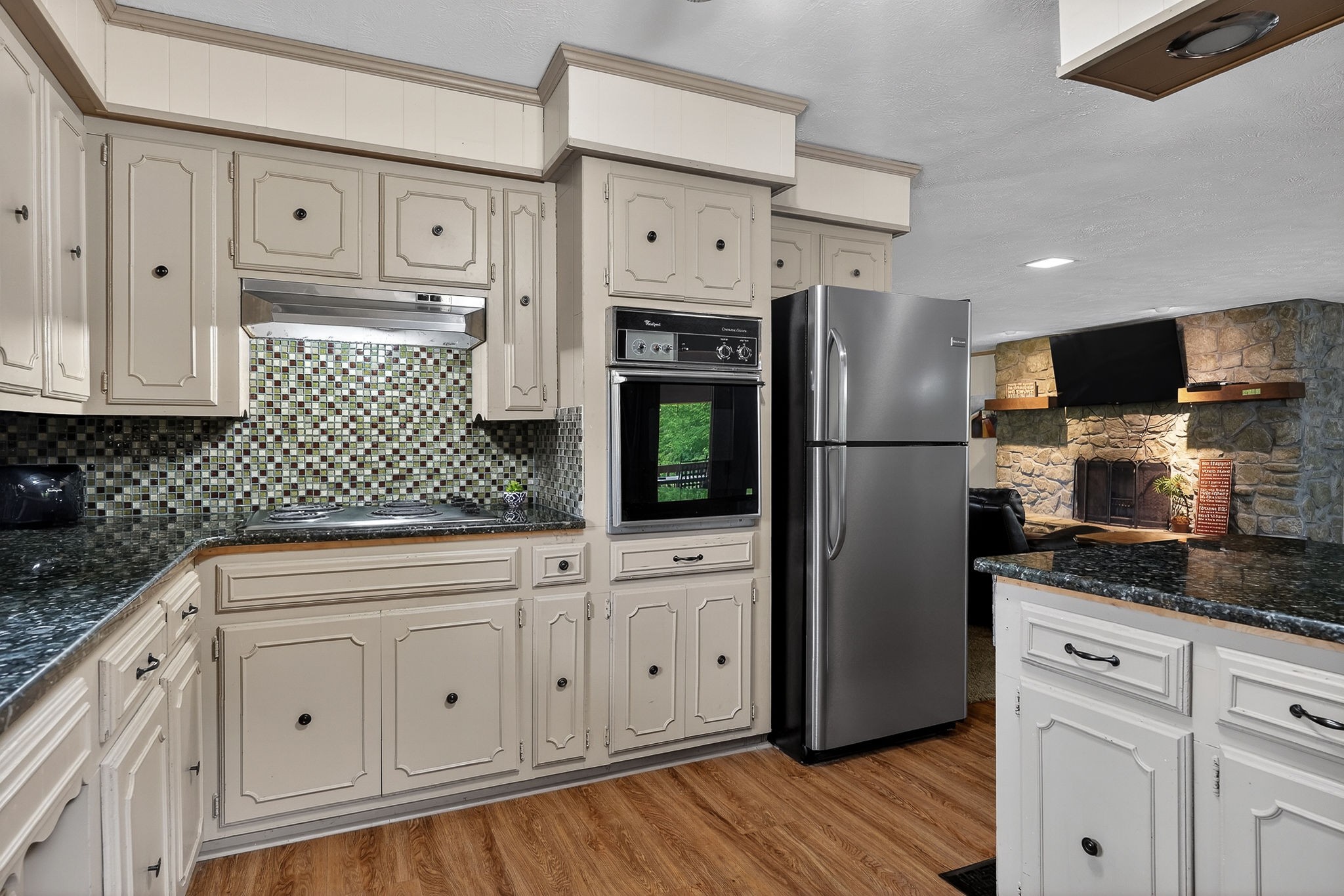 5642 Pates Ford Road Smithville, TN 37166 - Photo 9 of 32 a kitchen with white cabinets and stainless steel appliances
