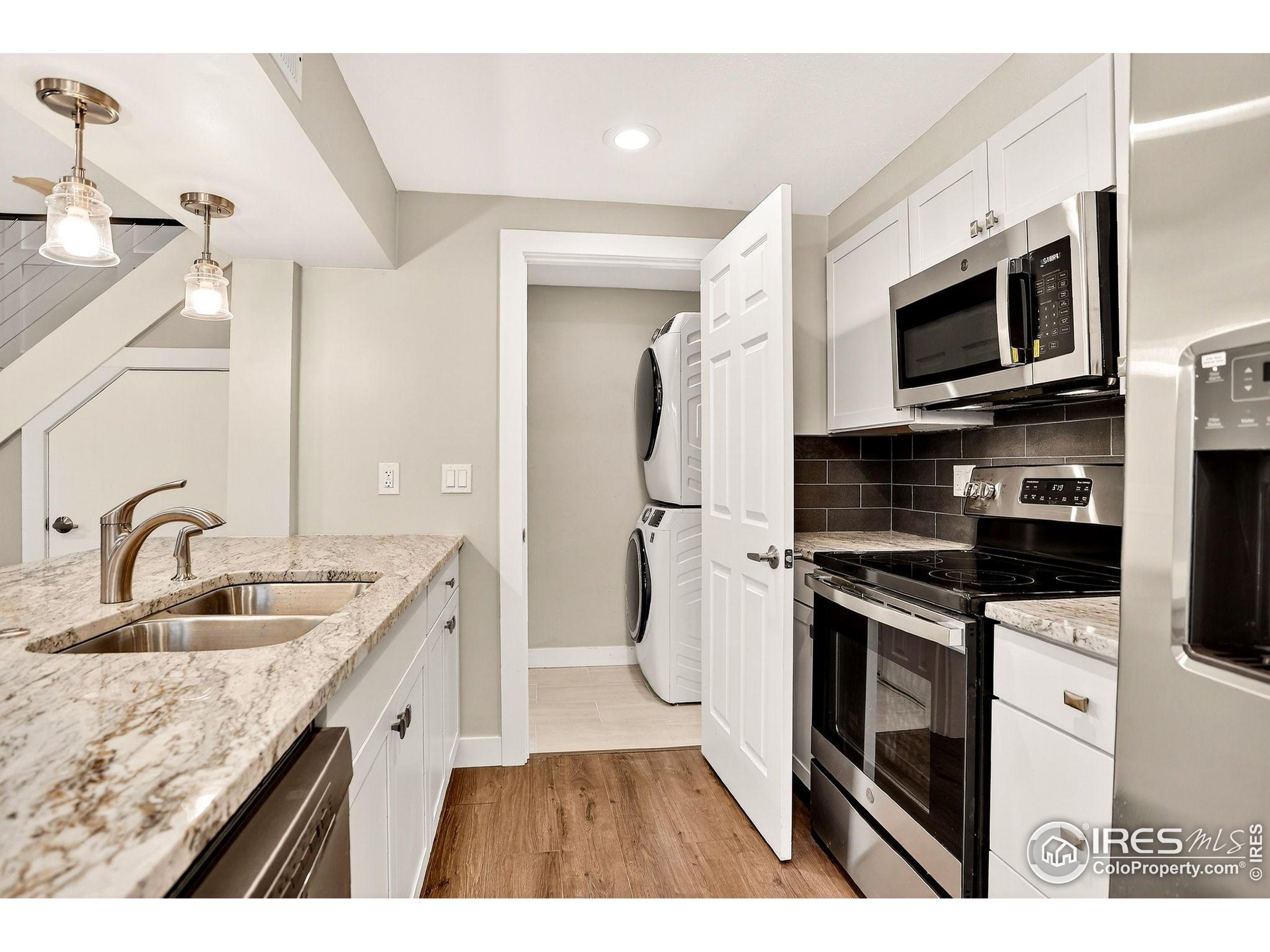 3360 34th Street, Unit B Boulder, CO 80301 - Photo 7 of 22 a kitchen with stainless steel appliances granite countertop a sink stove and refrigerator