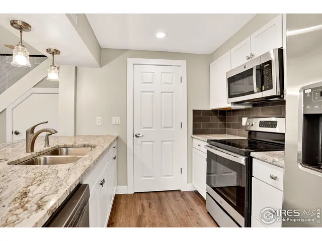 a kitchen with stainless steel appliances granite countertop a sink stove and microwave