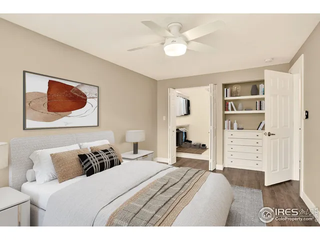 a bedroom with a bed and a painting on the wall