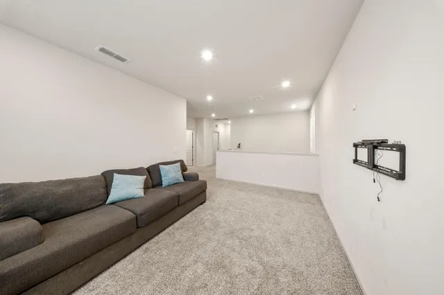 a large kitchen with stainless steel appliances a large counter top a stove and a refrigerator