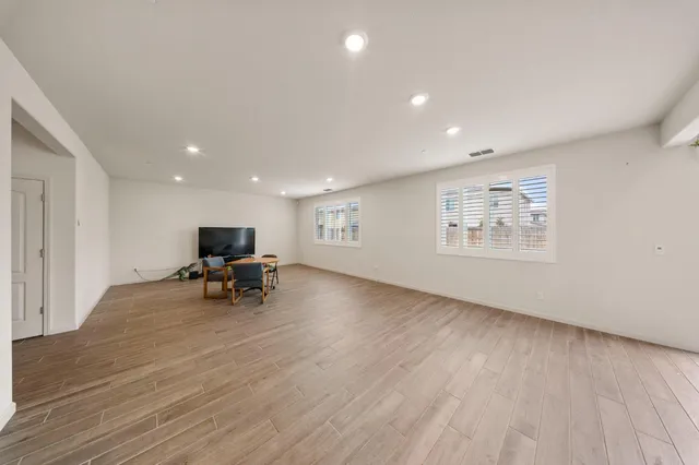 a view of a livingroom with a chair and wooden floor