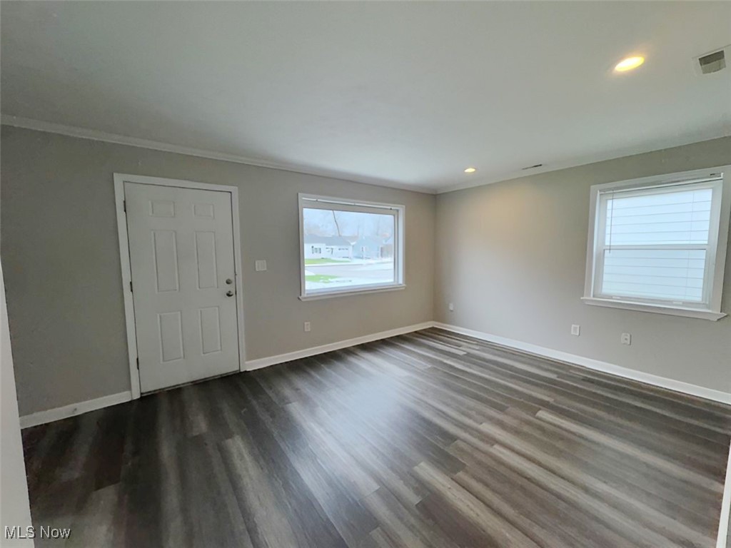 4842 Marigold Road Mentor, OH 44060 - Photo 5 of 13 Spare room with dark hardwood / wood-style floors and crown molding