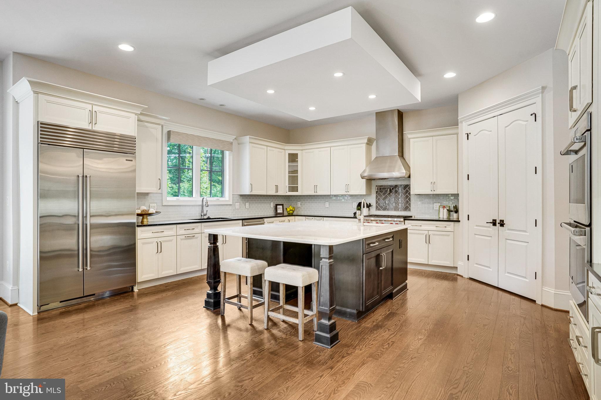 920 Ninovan Road Southeast Vienna, VA 22180 - Photo 11 of 44 a kitchen with a sink cabinets and wooden floor
