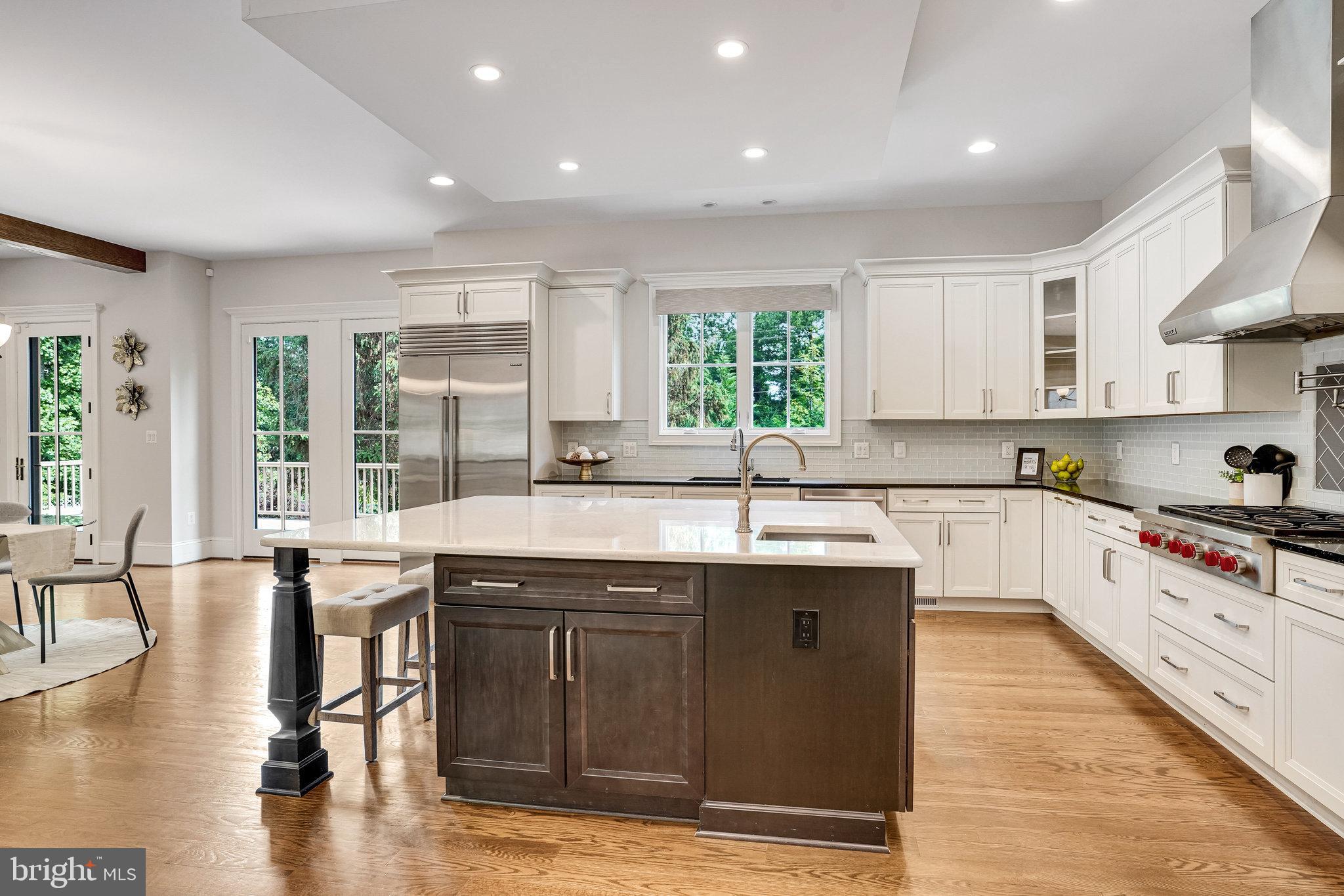 920 Ninovan Road Southeast Vienna, VA 22180 - Photo 13 of 44 a kitchen with stainless steel appliances granite countertop a stove a sink dishwasher and a microwave oven with wooden floor