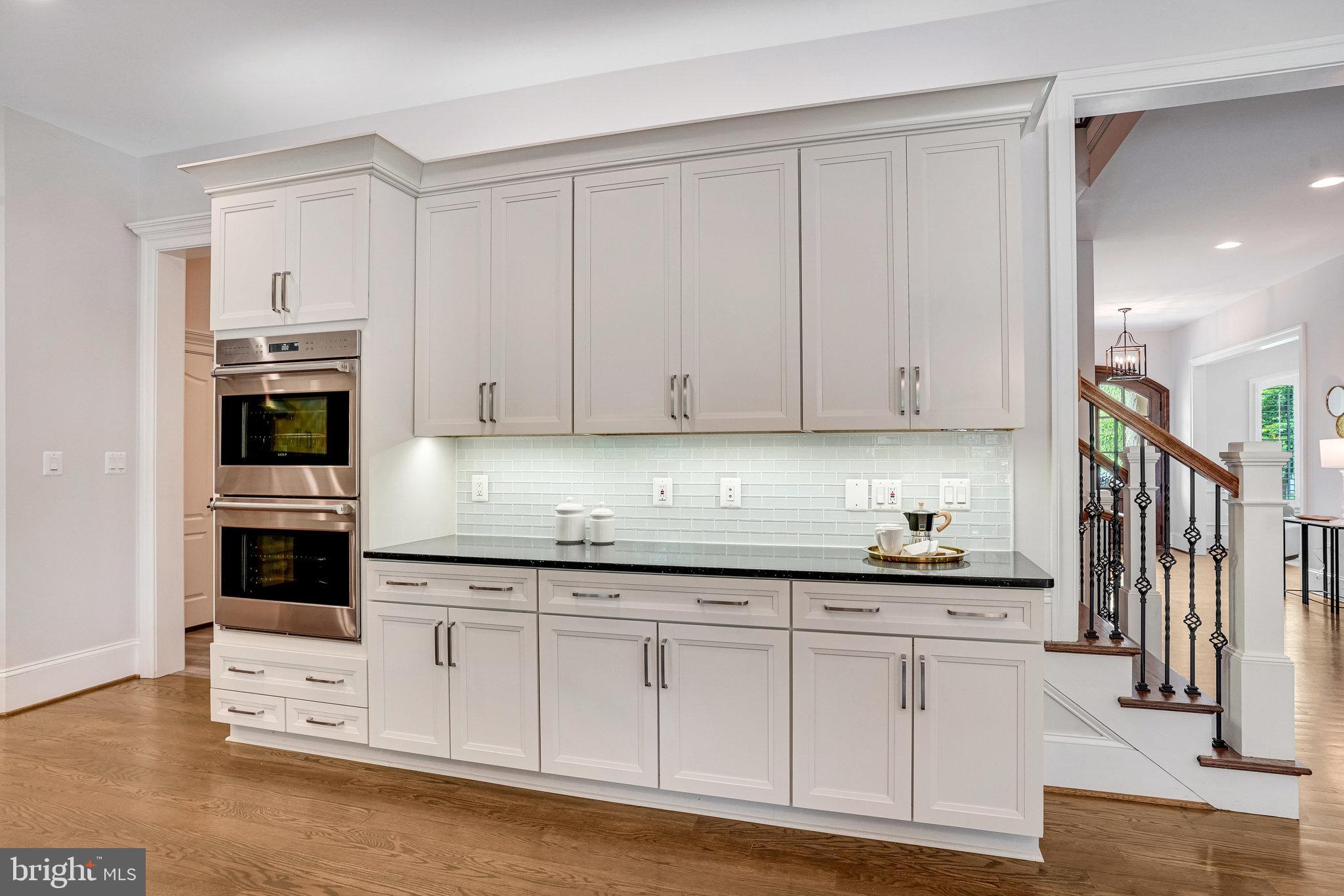 920 Ninovan Road Southeast Vienna, VA 22180 - Photo 15 of 44 a kitchen with stainless steel appliances granite countertop a stove a sink and white cabinets
