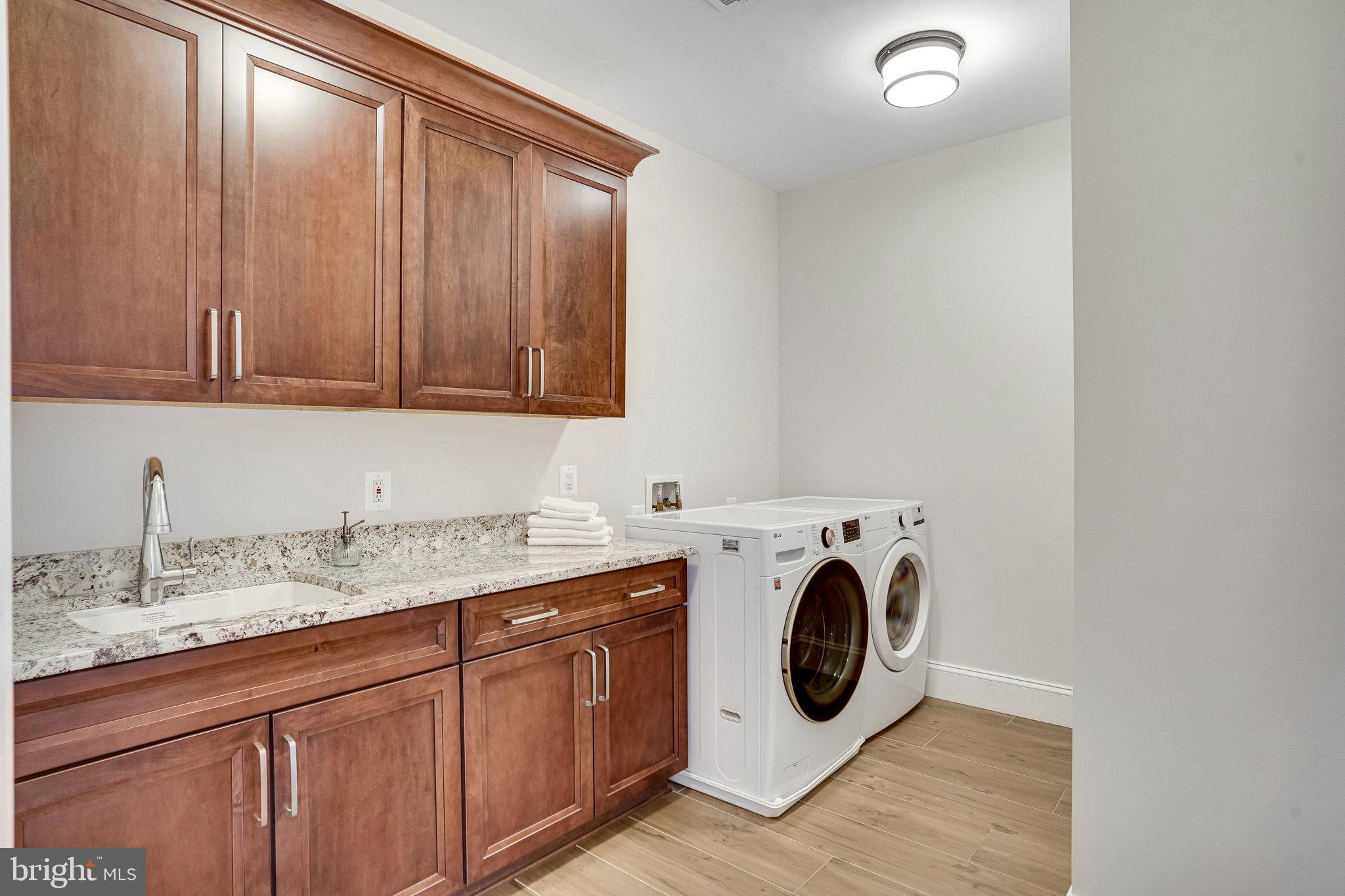 920 Ninovan Road Southeast Vienna, VA 22180 - Photo 31 of 44 a utility room with sink dryer and washer
