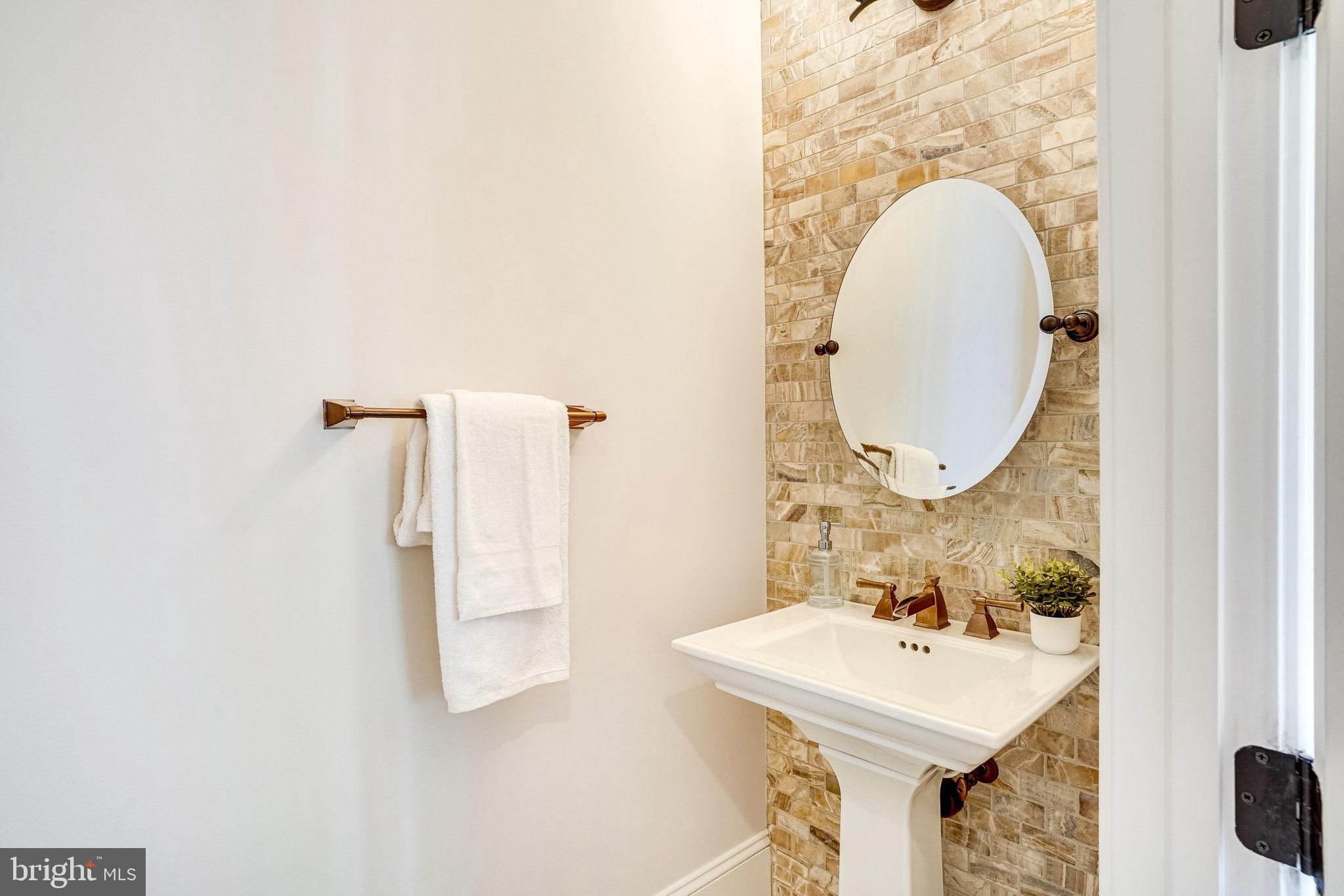 920 Ninovan Road Southeast Vienna, VA 22180 - Photo 9 of 44 a bathroom with a sink a mirror and a toilet