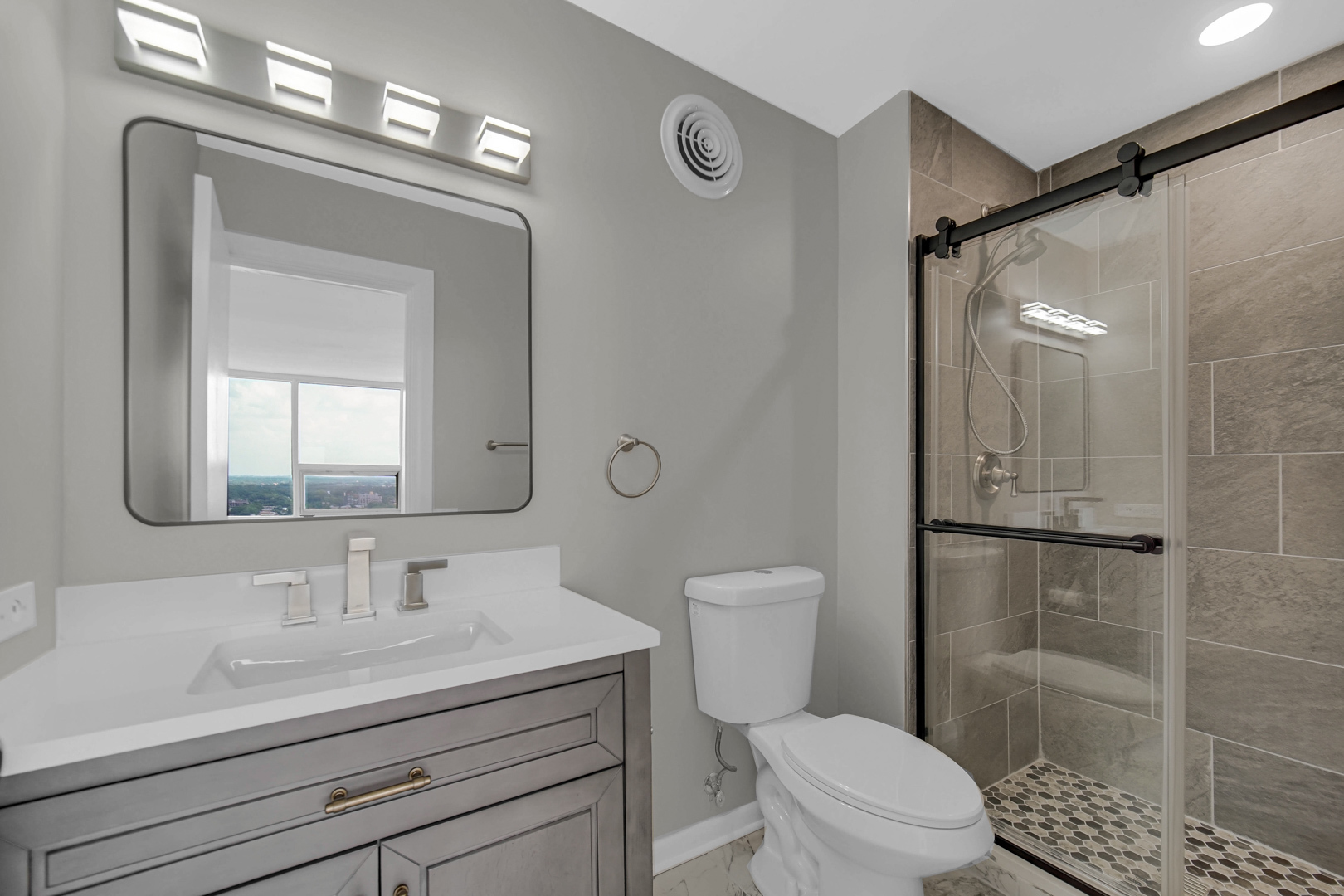 5733 North Sheridan Road, Unit 27C Chicago, IL 60660 - Photo 13 of 23 a bathroom with a sink a toilet and shower