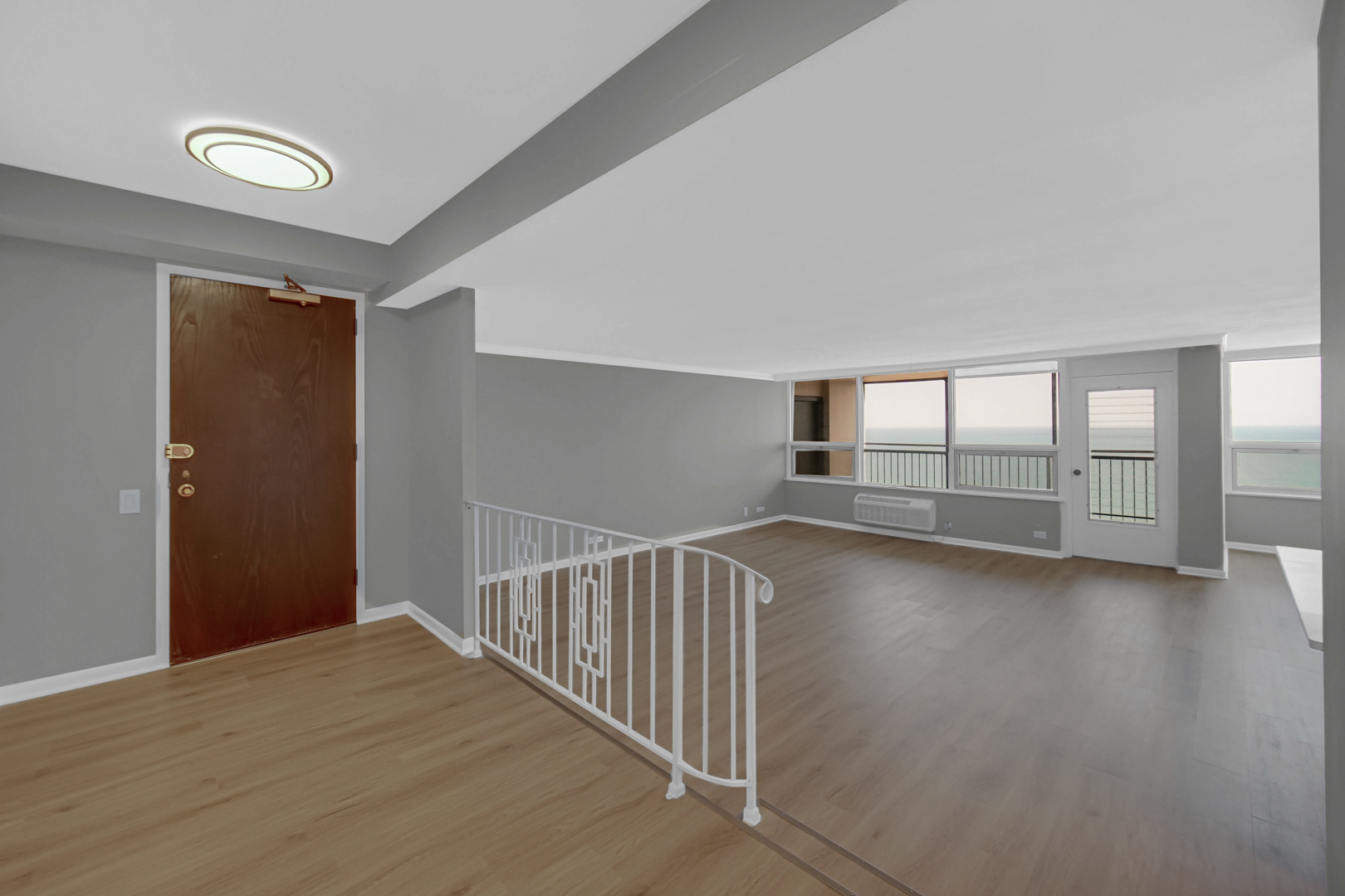 5733 North Sheridan Road, Unit 27C Chicago, IL 60660 - Photo 7 of 23 a view of livingroom with floor to ceiling window