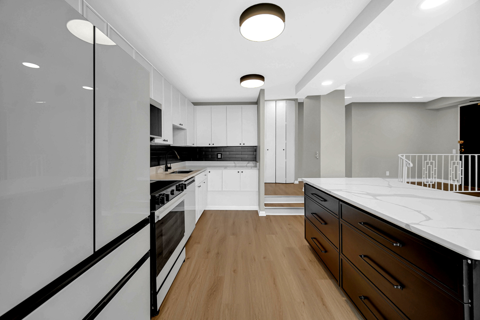 5733 North Sheridan Road, Unit 27C Chicago, IL 60660 - Photo 9 of 23 a kitchen with granite countertop a sink appliances cabinets and counter space