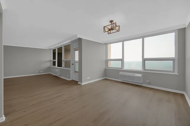 wooden floor in an empty room with a window