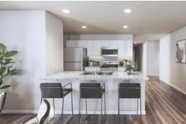 a kitchen with kitchen island granite countertop a counter top space cabinets and stainless steel appliances