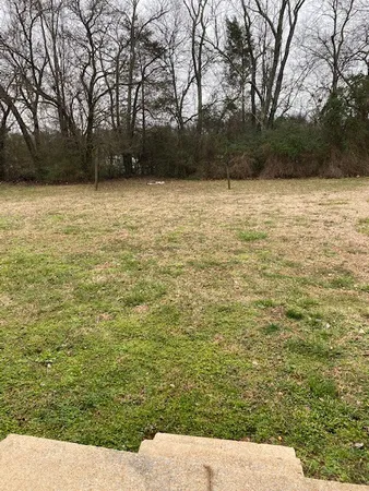 a view of pool with green space