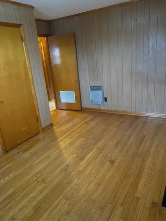 a view of an empty room with wooden door