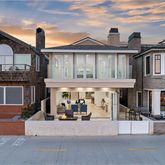 a view of a big house with large windows and a small yard