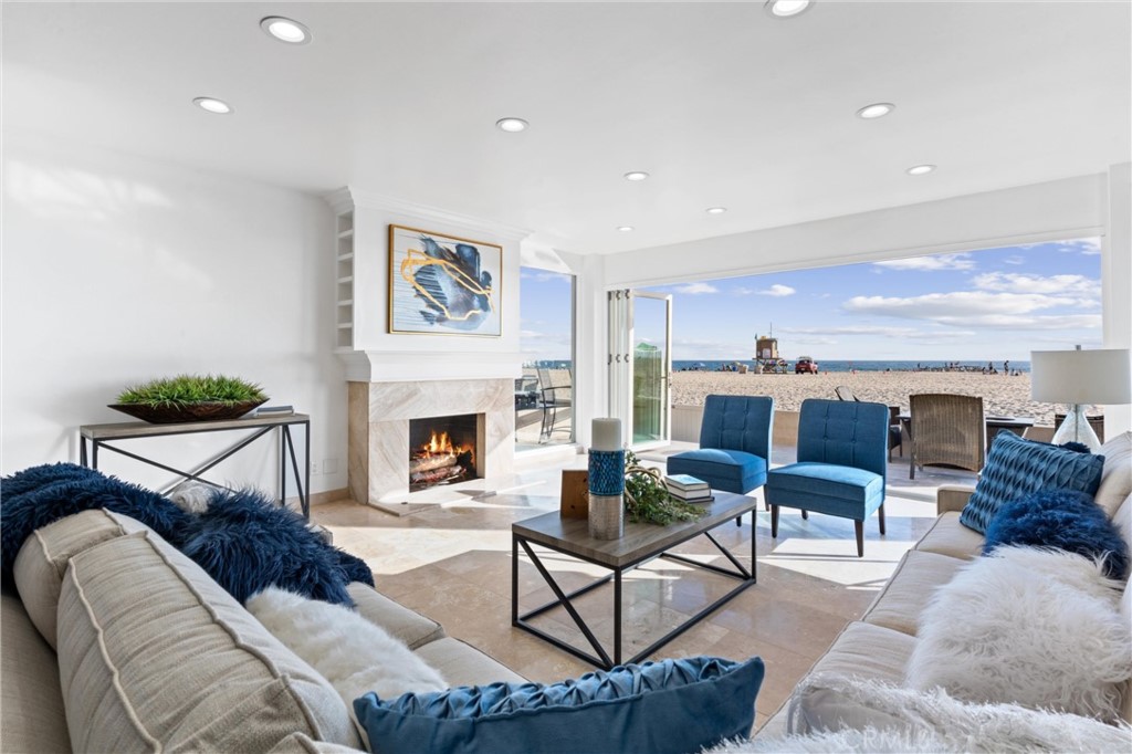 2804 West Oceanfront Newport Beach, CA 92663 - Photo 2 of 16 a living room with furniture and a fireplace