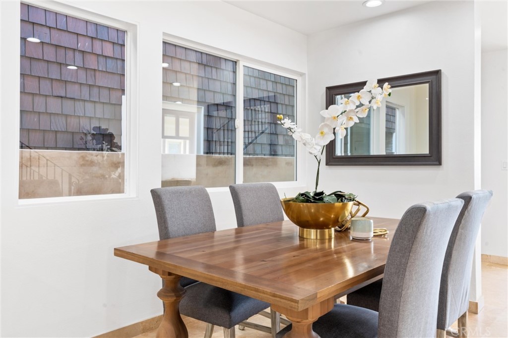 2804 West Oceanfront Newport Beach, CA 92663 - Photo 5 of 16 a view of a dining room with furniture and wooden floor